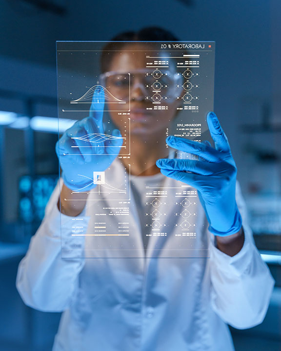 Woman in a lab coat looking at a futuristic computer screen