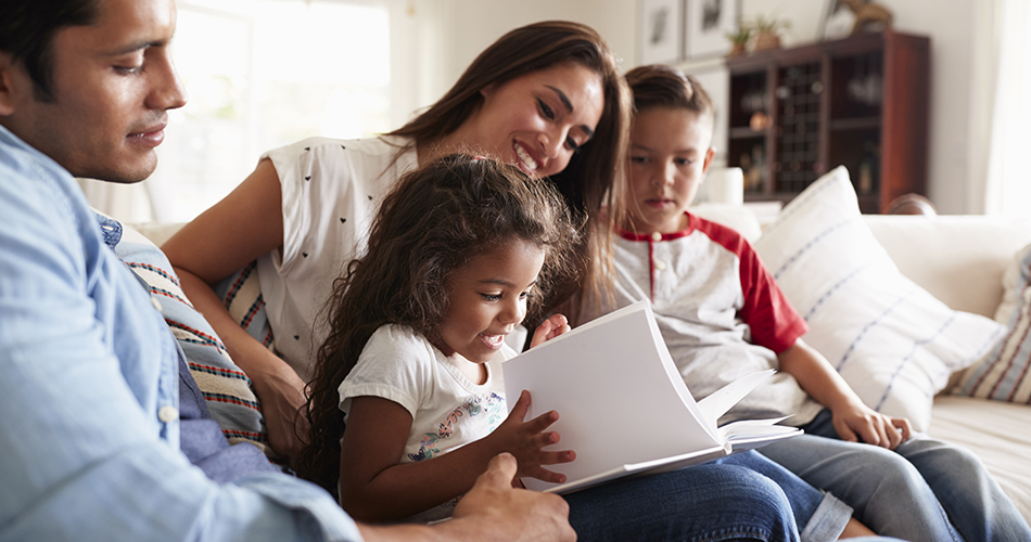 Image of Hispanic family reading together at home