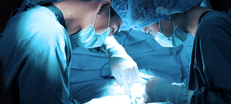 two surgeons working on a patient