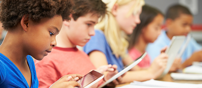 Image of a row of students using iPads