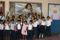 Kids in front of a Project EXCELENCIA poster