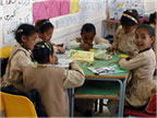Photo of young students at a school table.