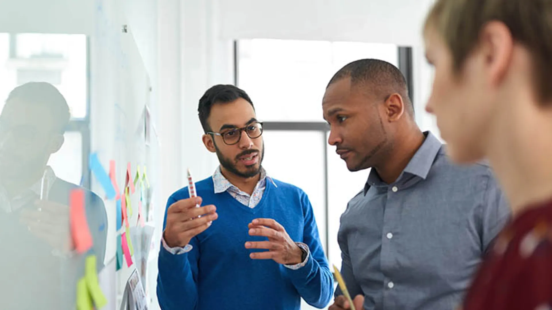 Coworkers collaborating at whiteboard