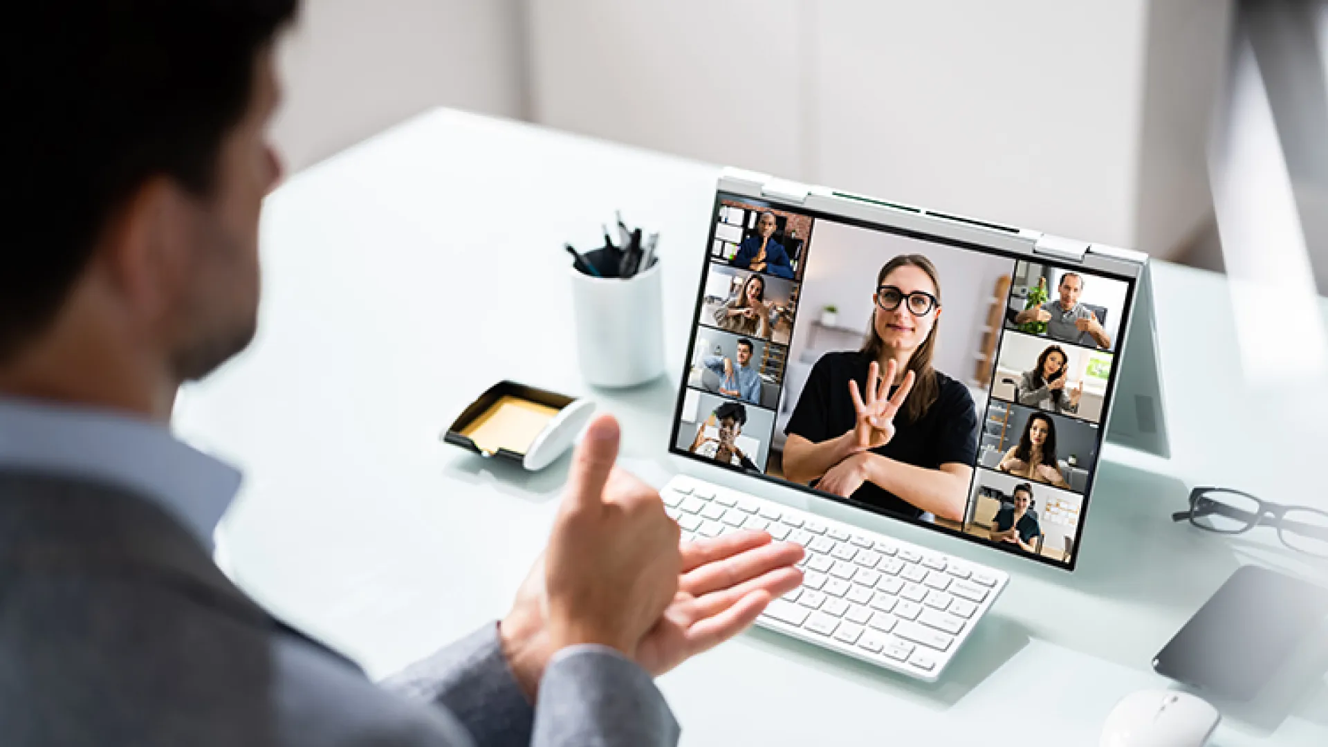 Colleagues using sign language during a virtual meeting