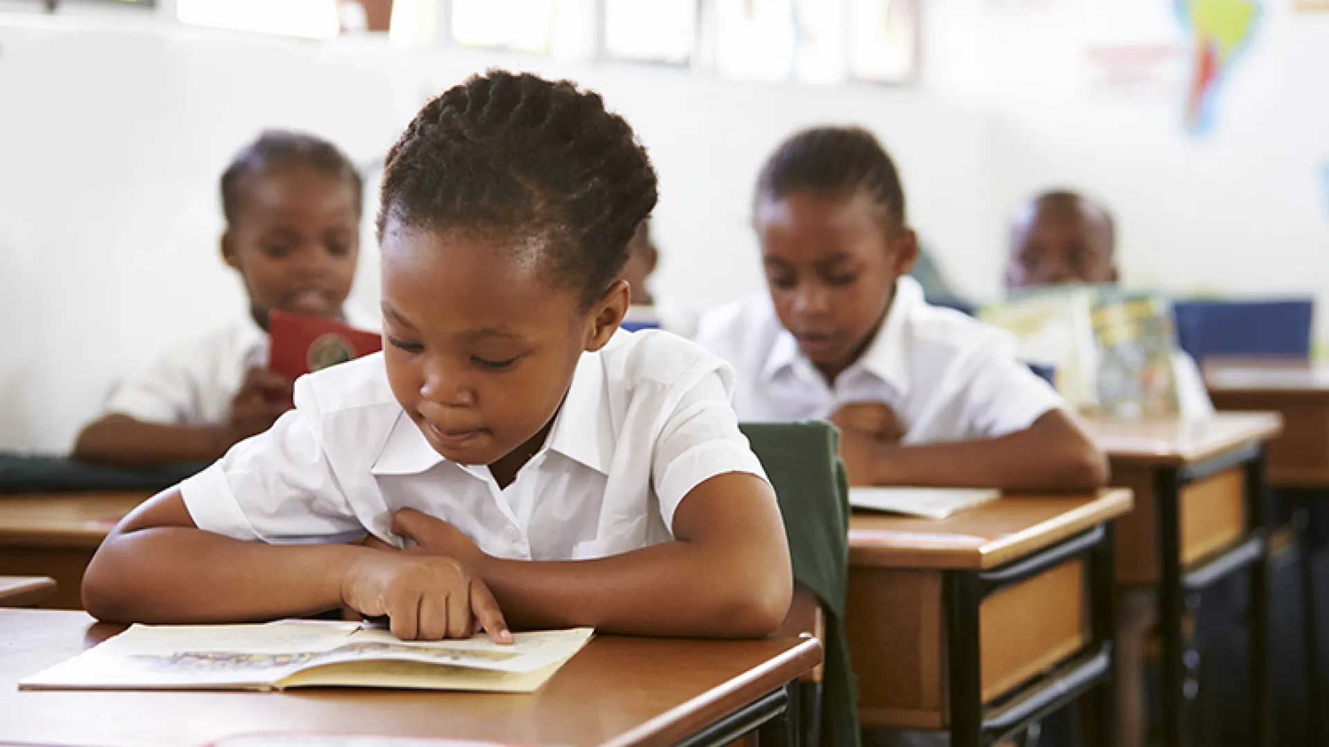 African child reading in a classroom