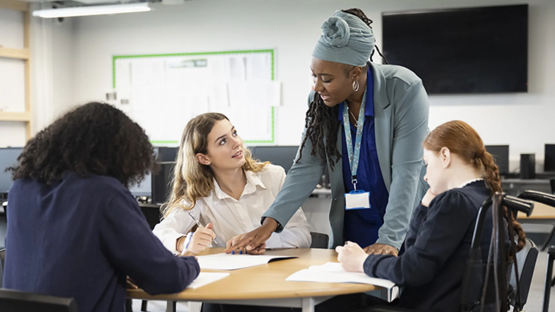 Teacher with high school students in classroom