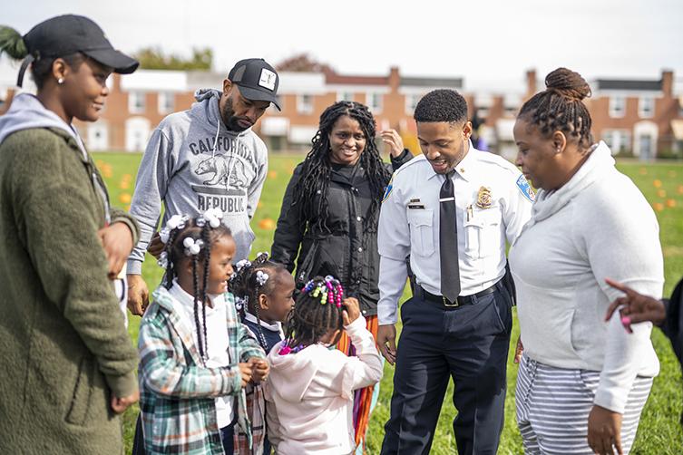 Baltimore police officer with community members