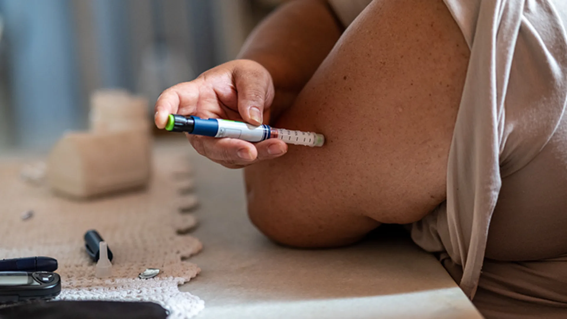 Woman injecting herself with insulin