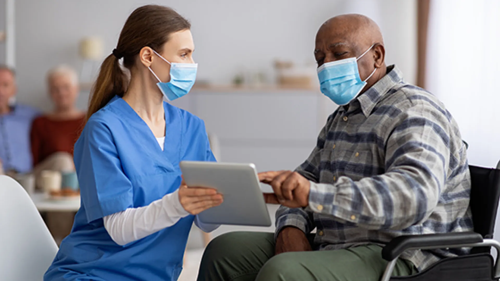 Older male patient and health care worker