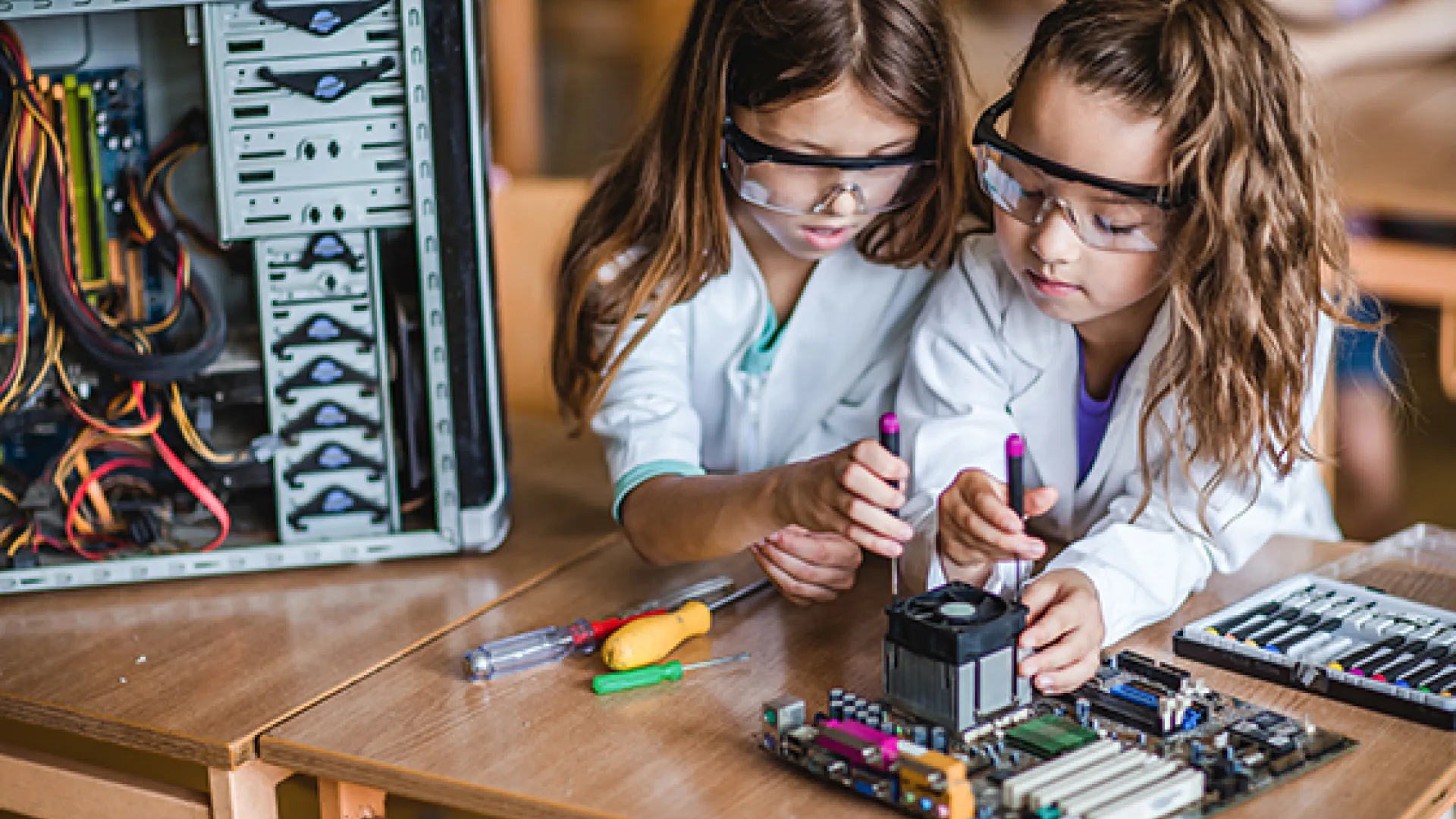 Two young girls working together on a STEM project