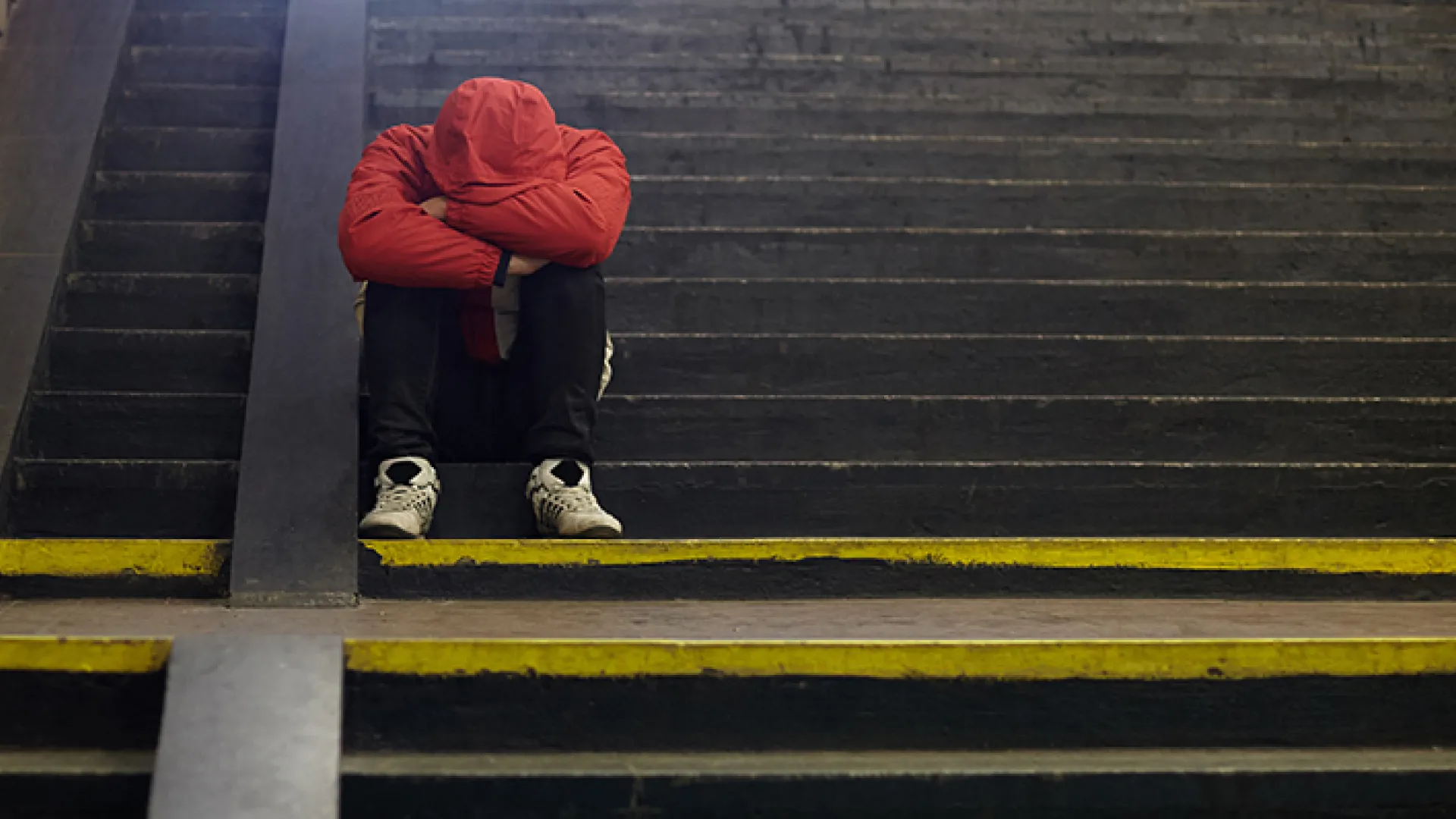 Sad teenager with head in his hands
