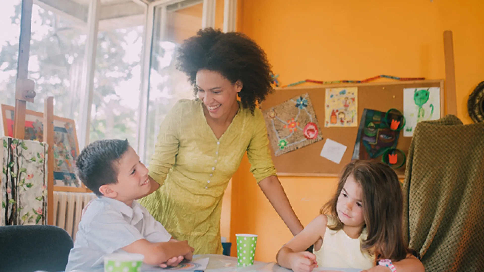 Teacher with two young students