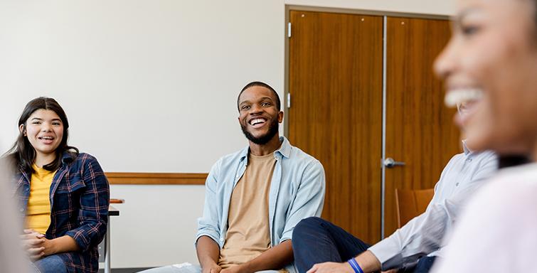Young man smiling in therapy group