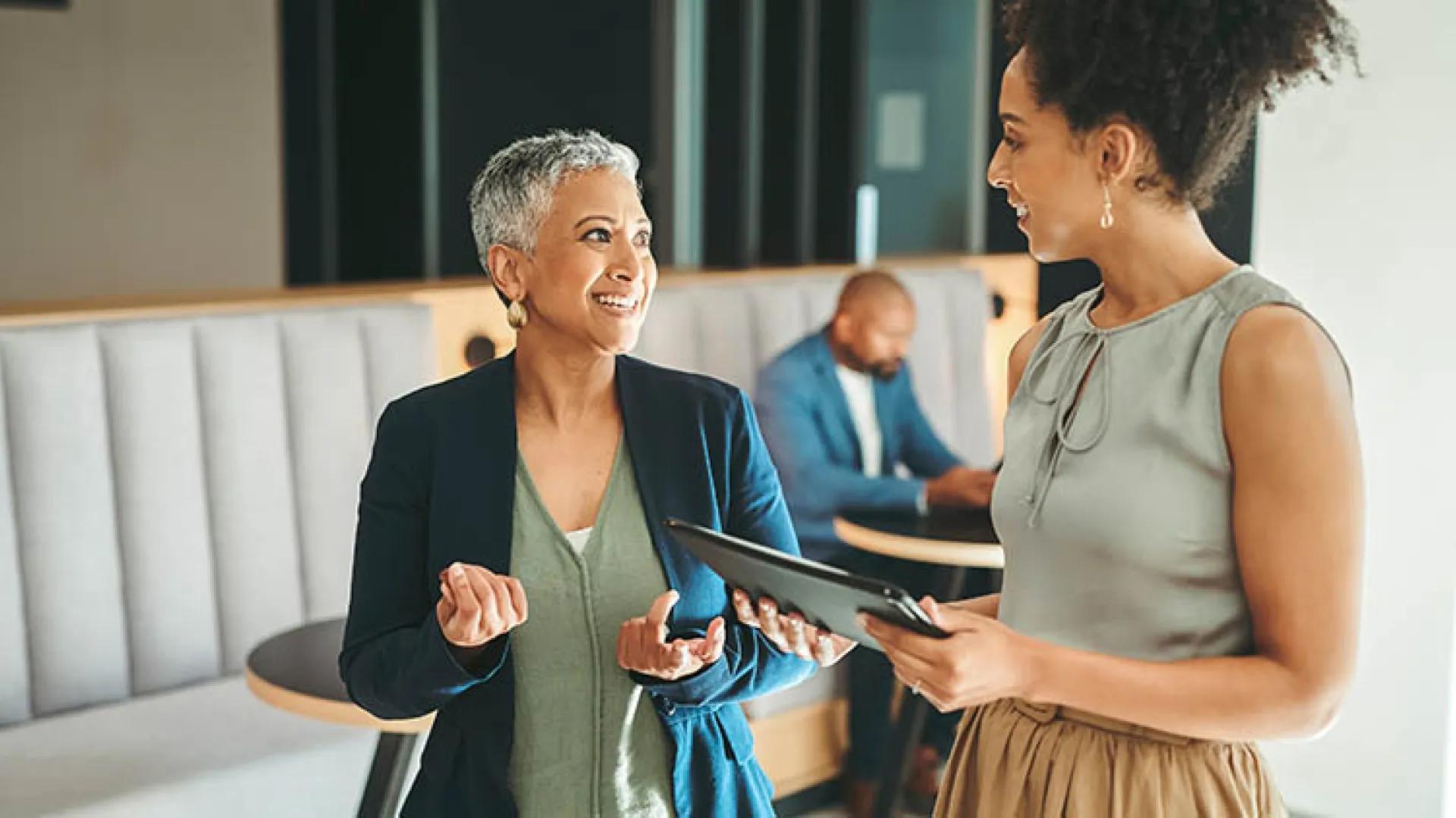 Two women colleagues walking and talking