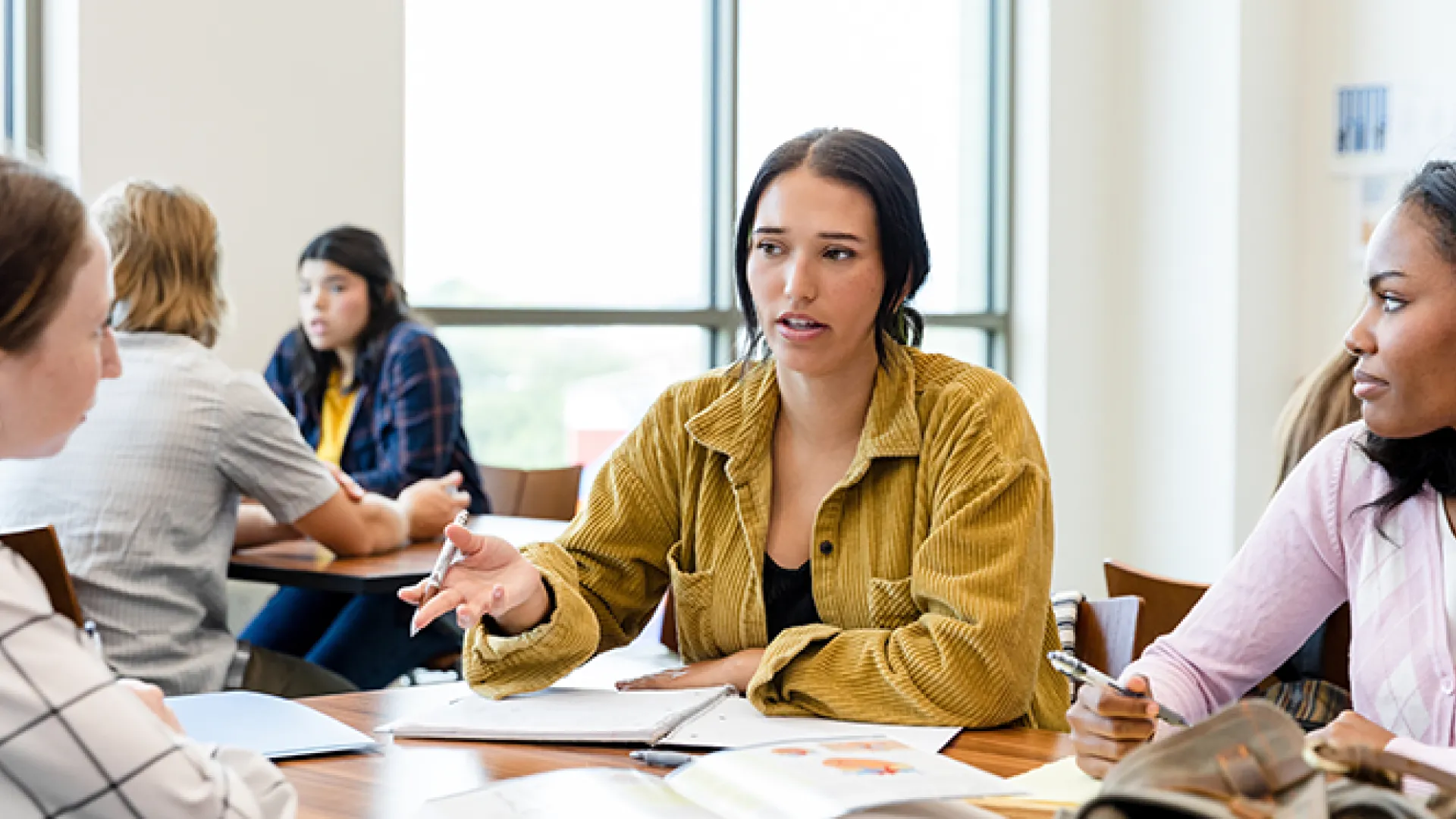 Students at table with notebooks