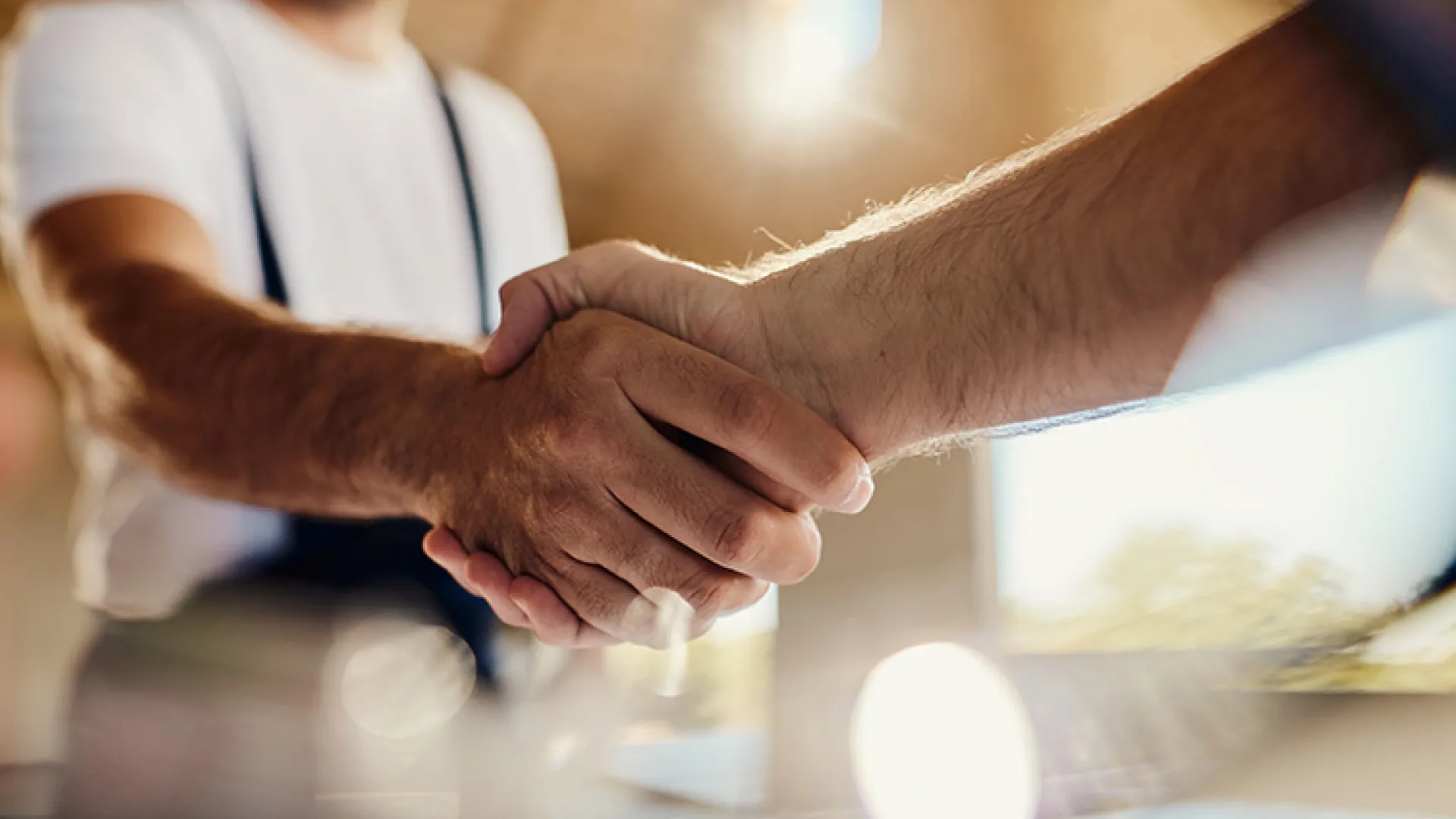 Factory workers shaking hands