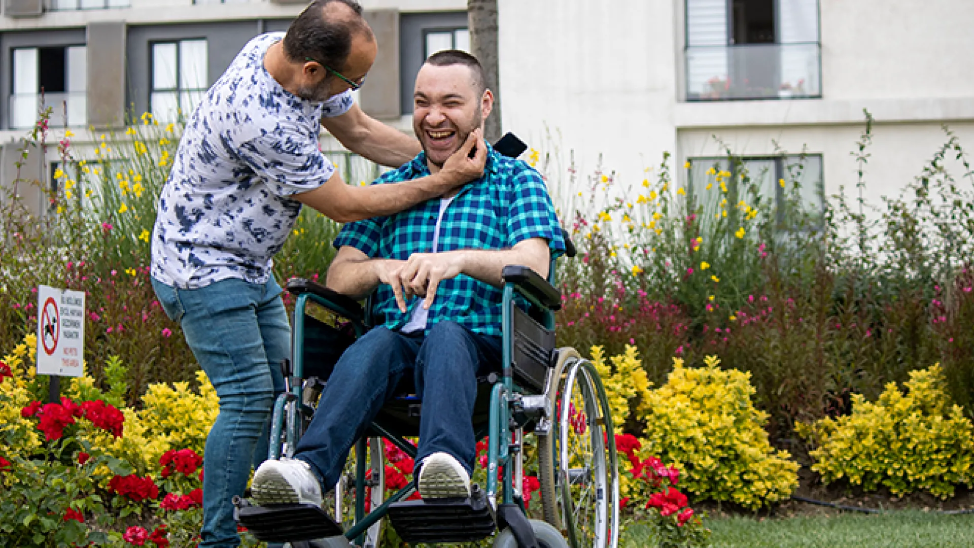 Handicapped boy spending time with his father in a wheelchair