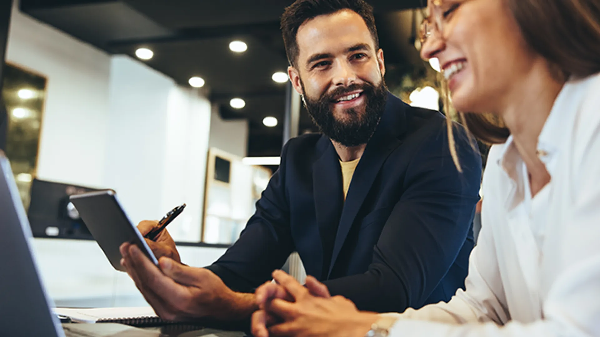 Happy entrepreneurs having a discussion in an office