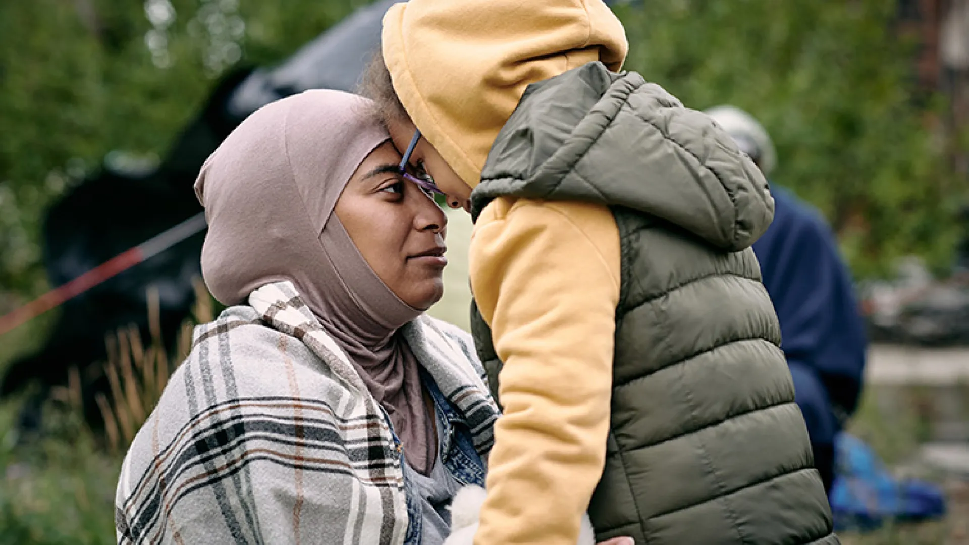 Mother in niqab with child face to face