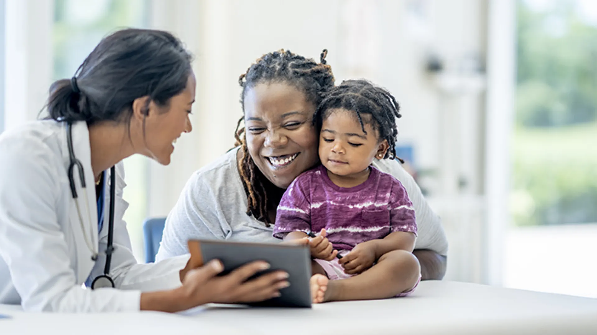 Smiling mother and child with doctor