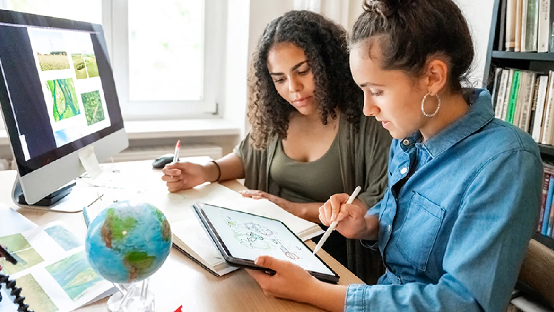 Two young women working on climate change project