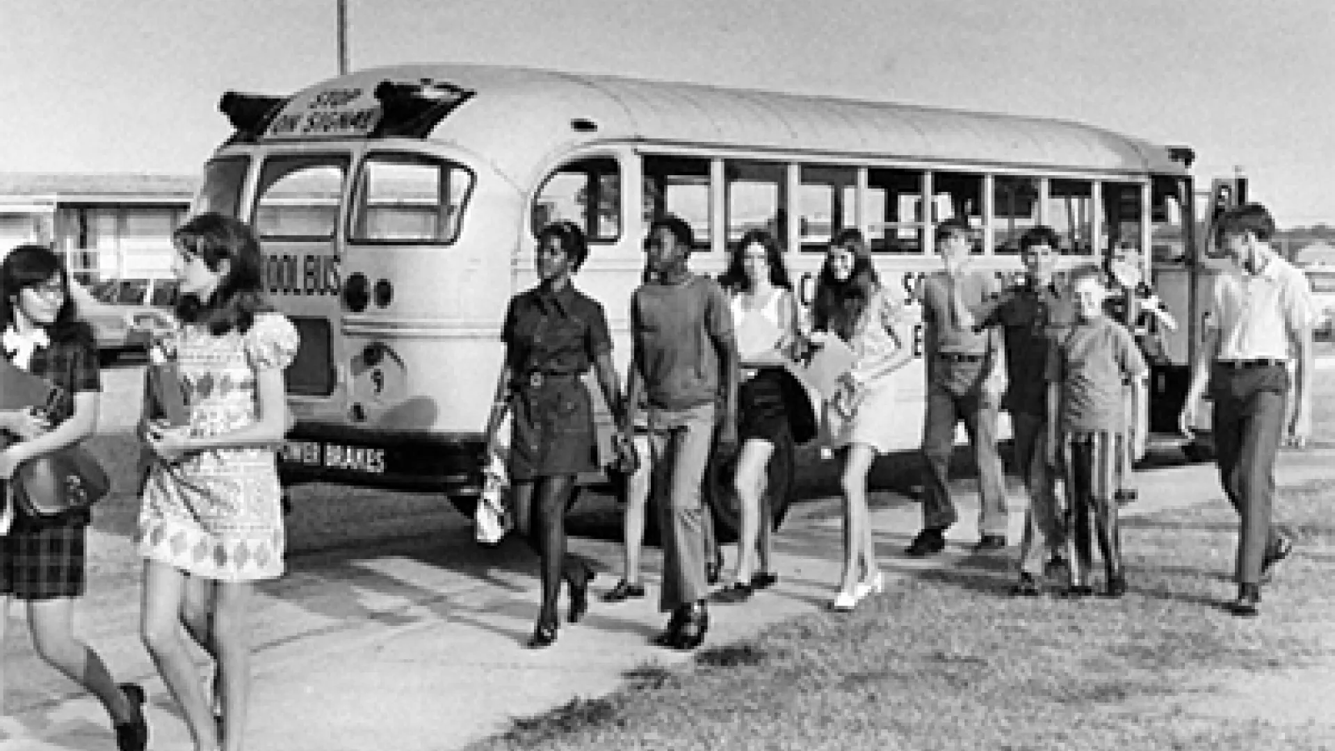 Project Talent students walking by a schoolbus