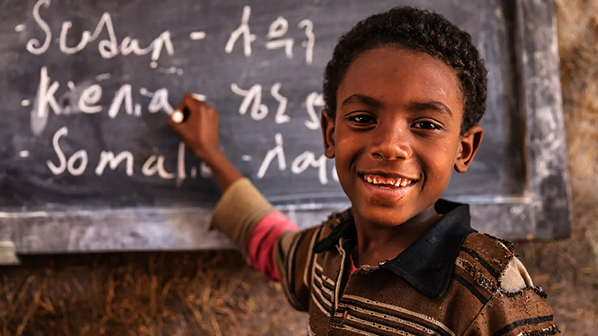 African young boy is learning Amharic language