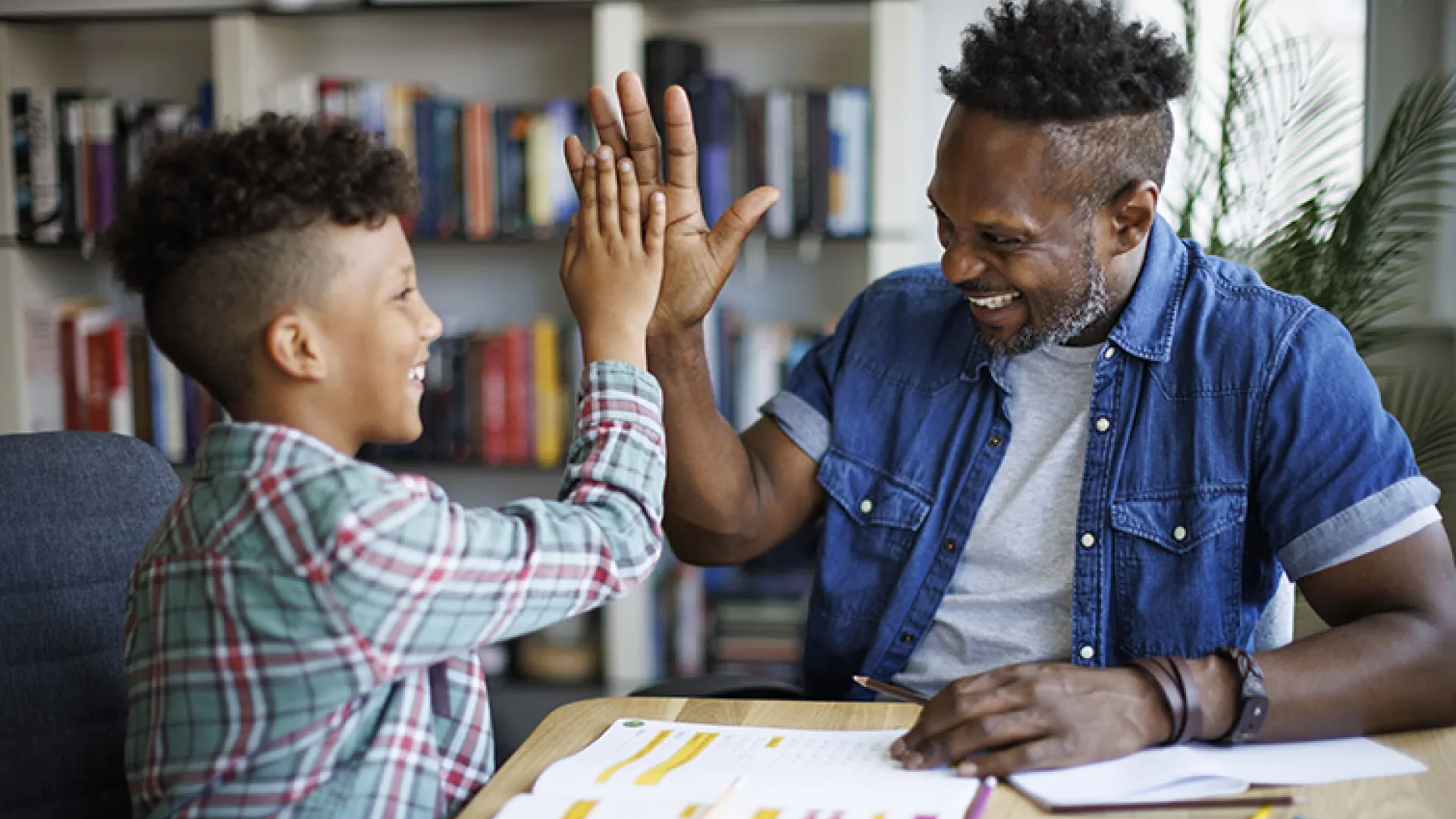 Teacher and student high-fiving