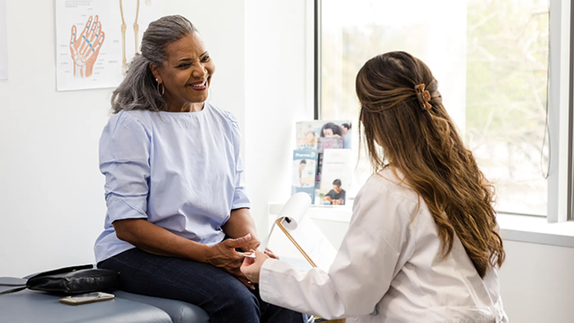 Female doctor talks to her senior adult patient about preventative lab work she should have completed