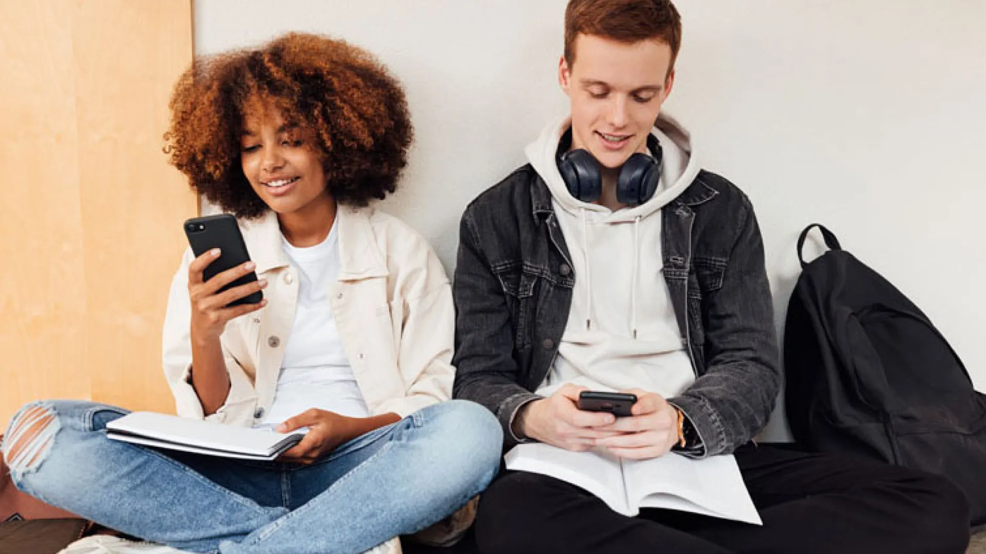 College students sitting in a hallway