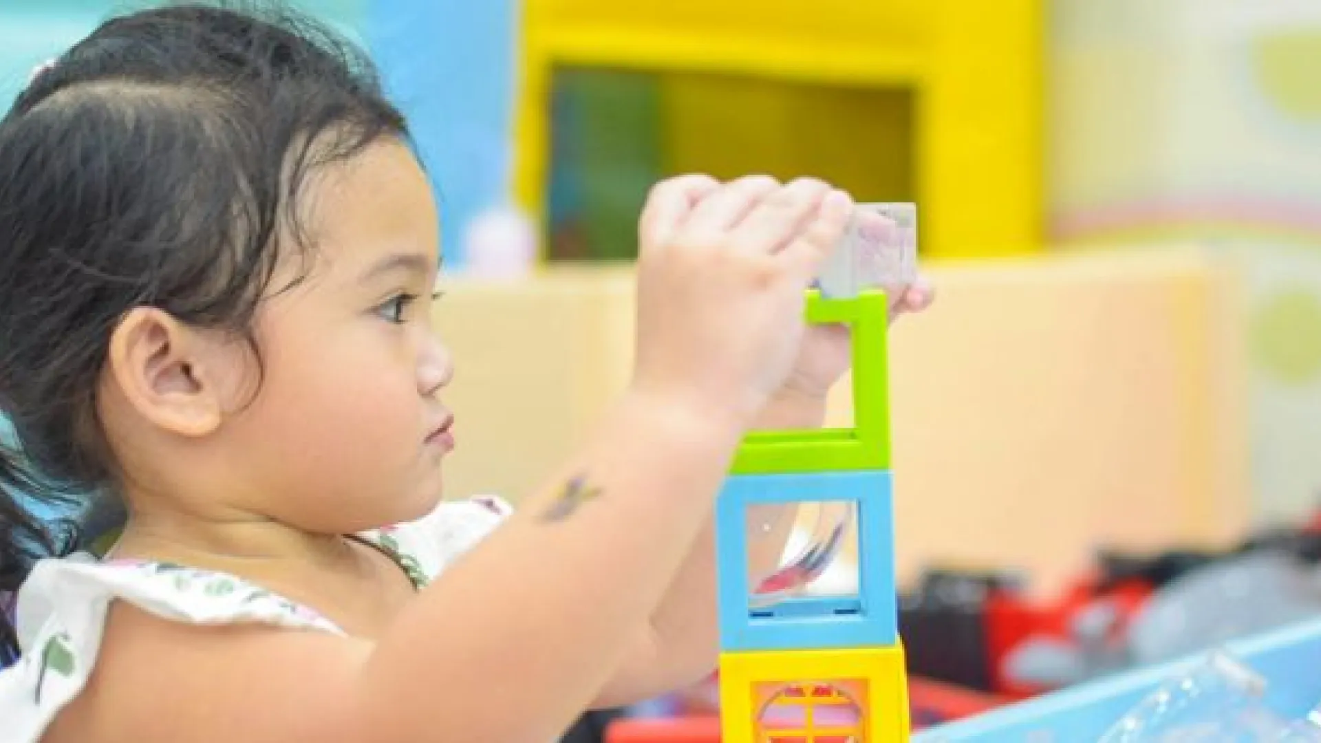 preschool girl stacking blocks