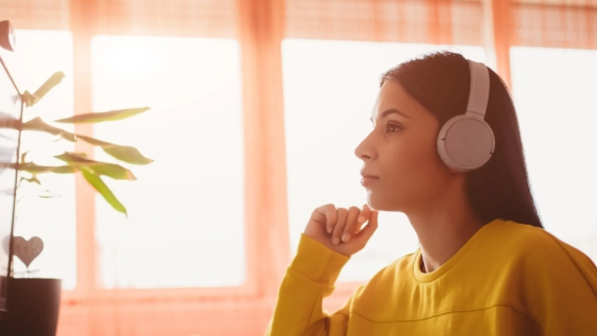 Teacher seated at computer wearing headphones