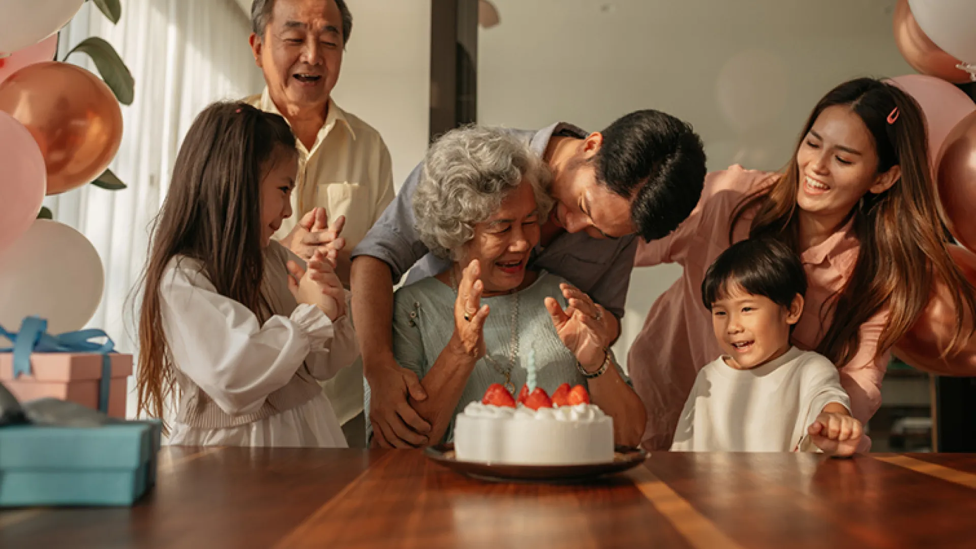 Multigenerational family celebrating grandmother's birthday