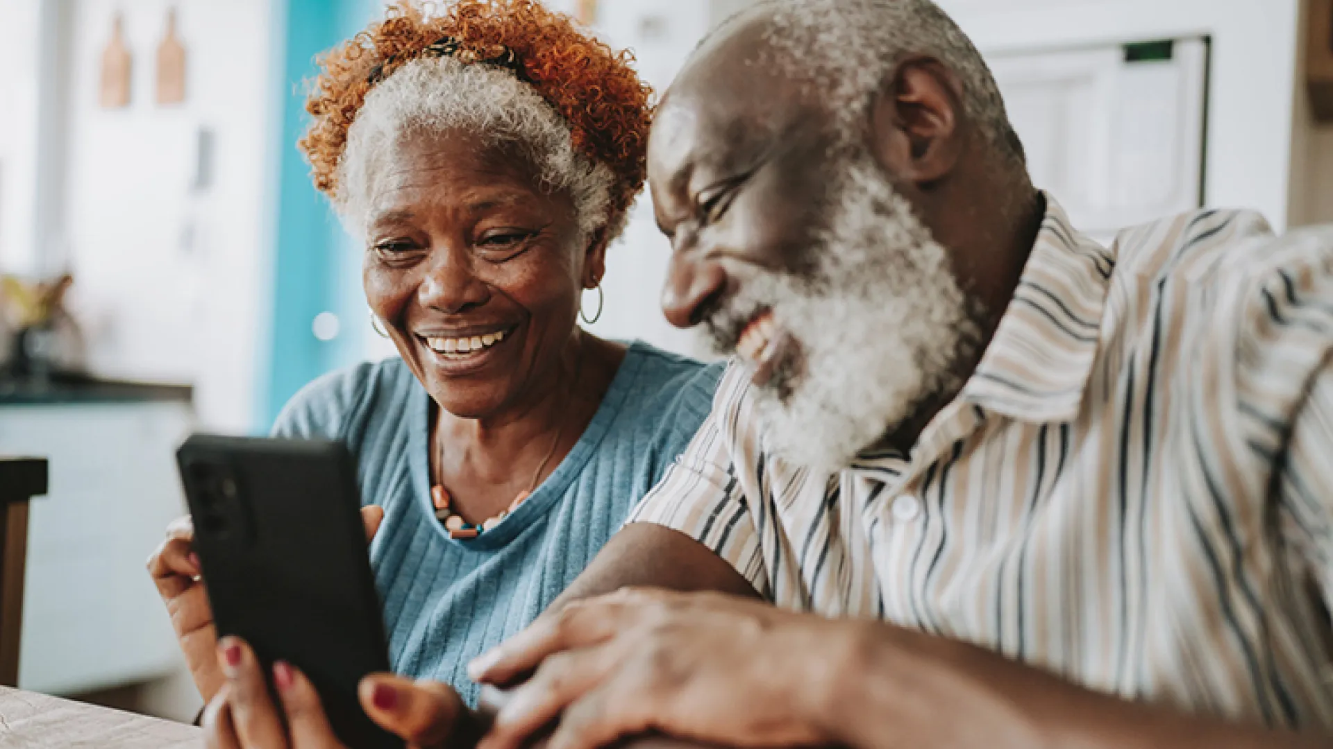 Older couple looking at a phone together
