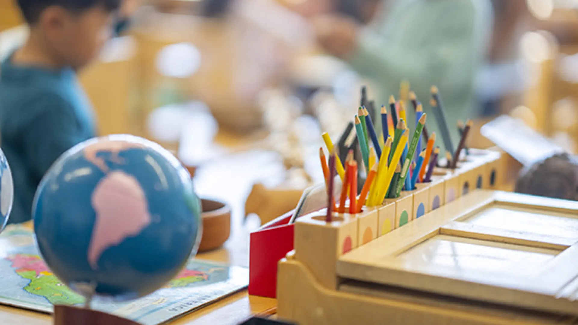 Social studies classroom showing a globe and colored pencils