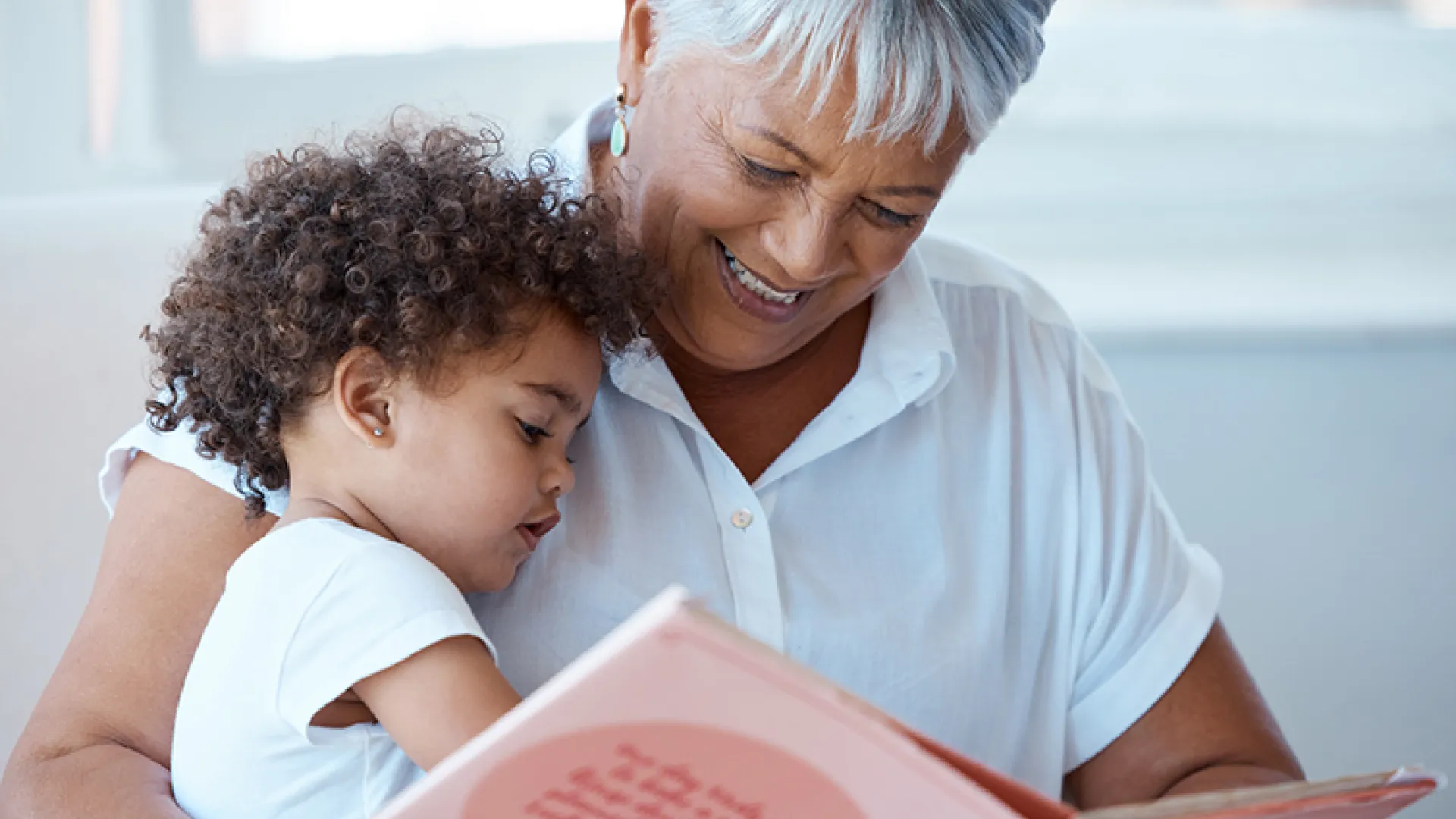 mature woman reading to small child