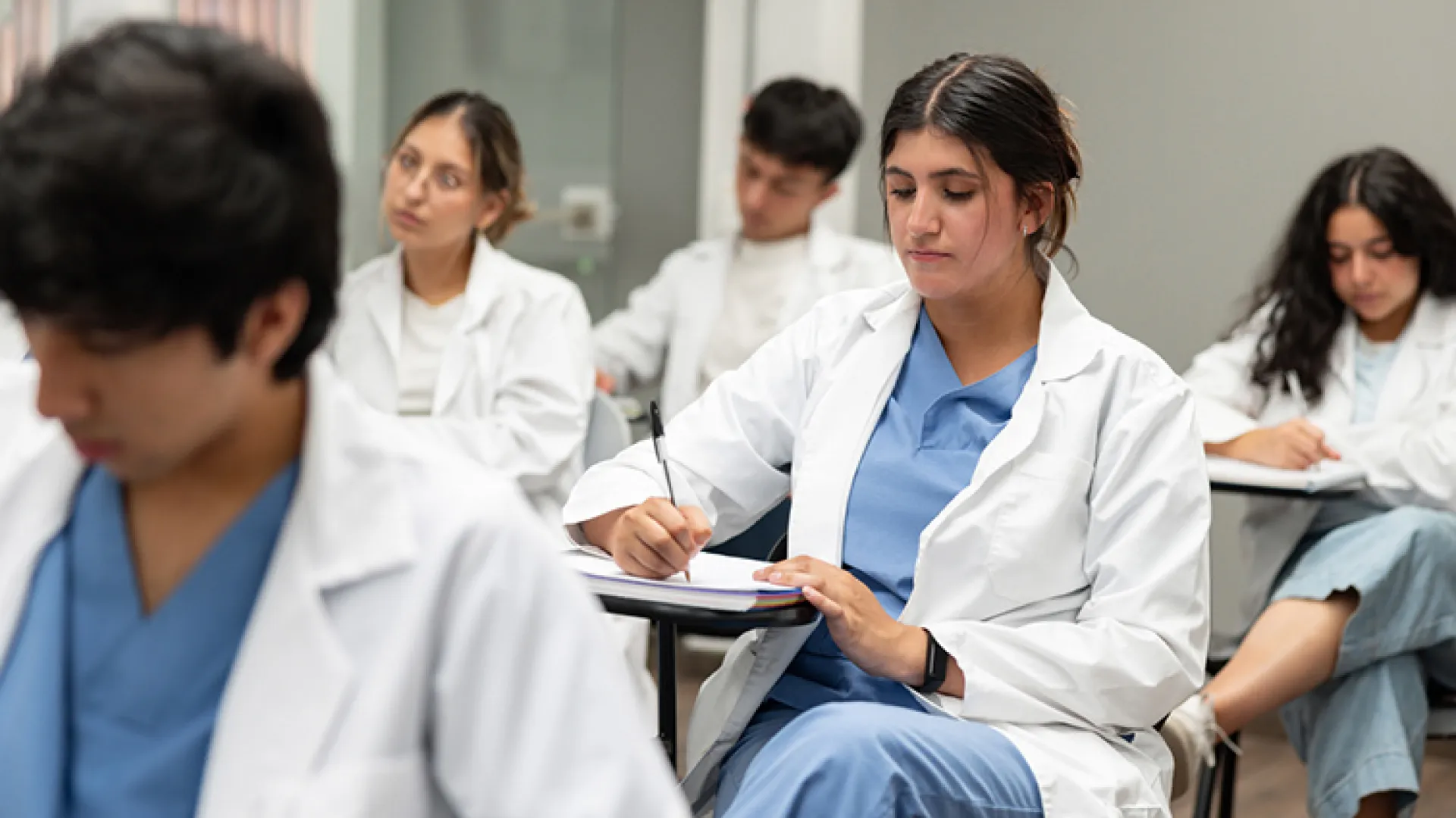 medical student taking notes in class