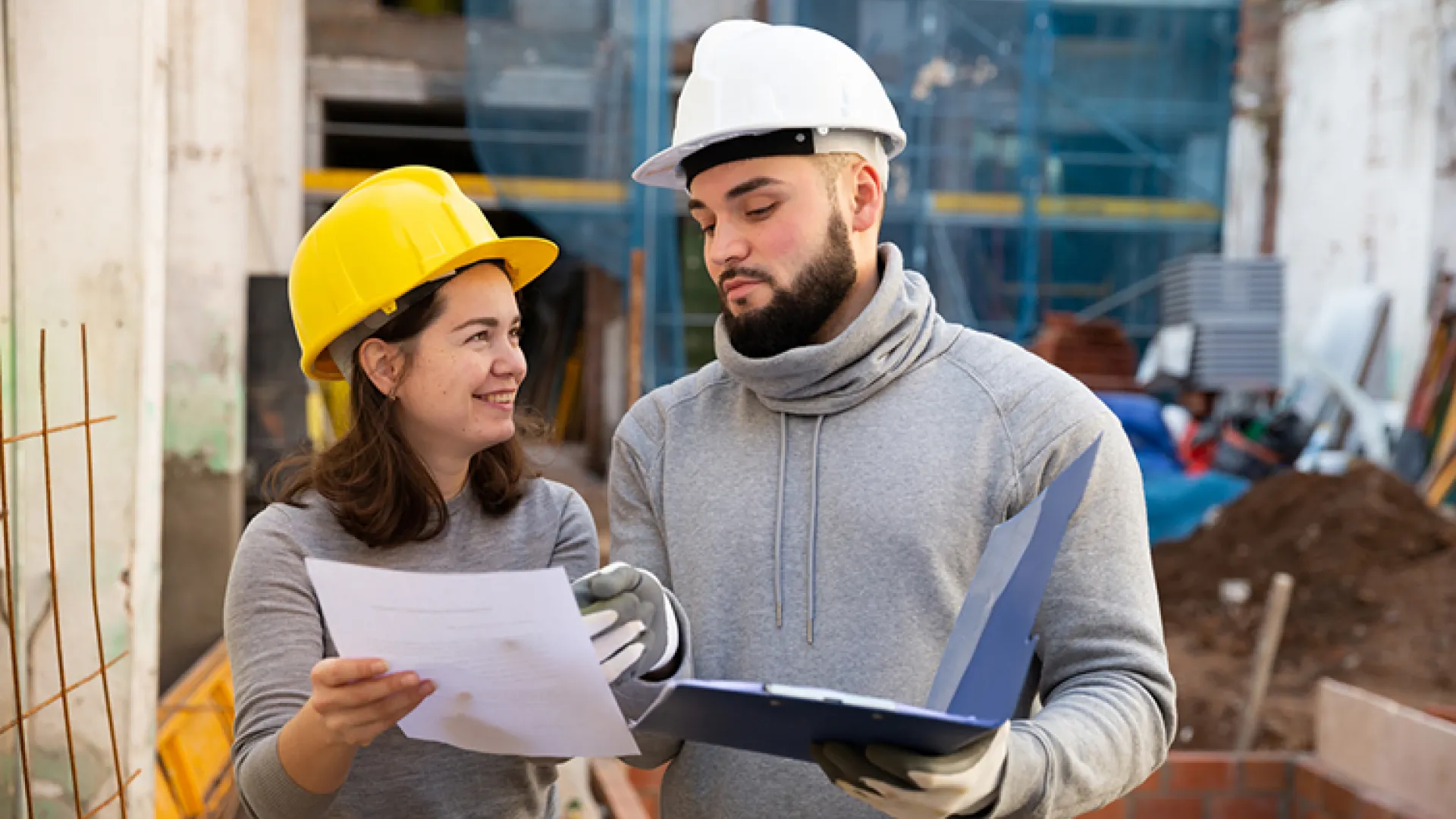 apprentice and supervisor talking in hardhats