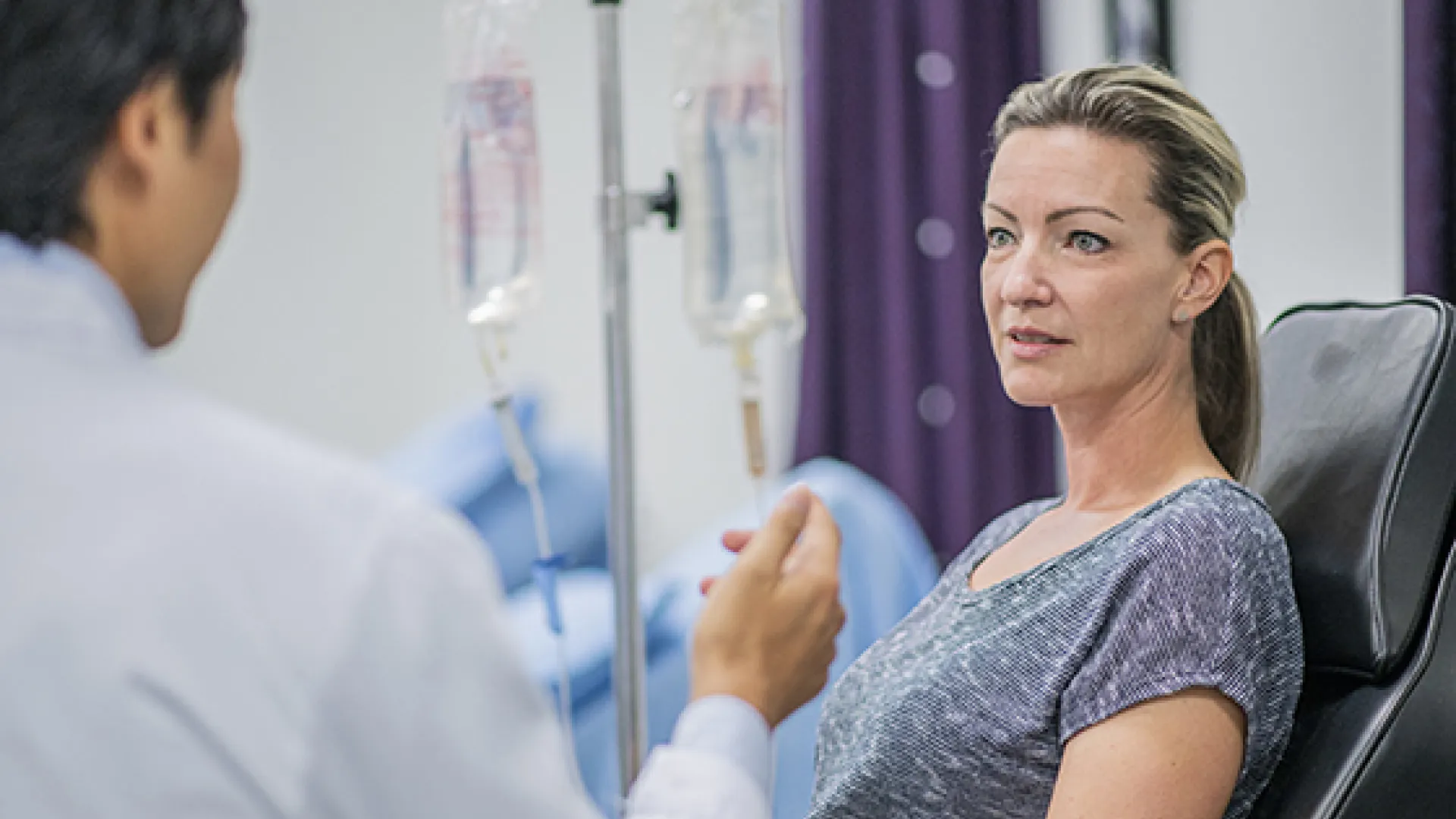 woman with iv talking to doctor