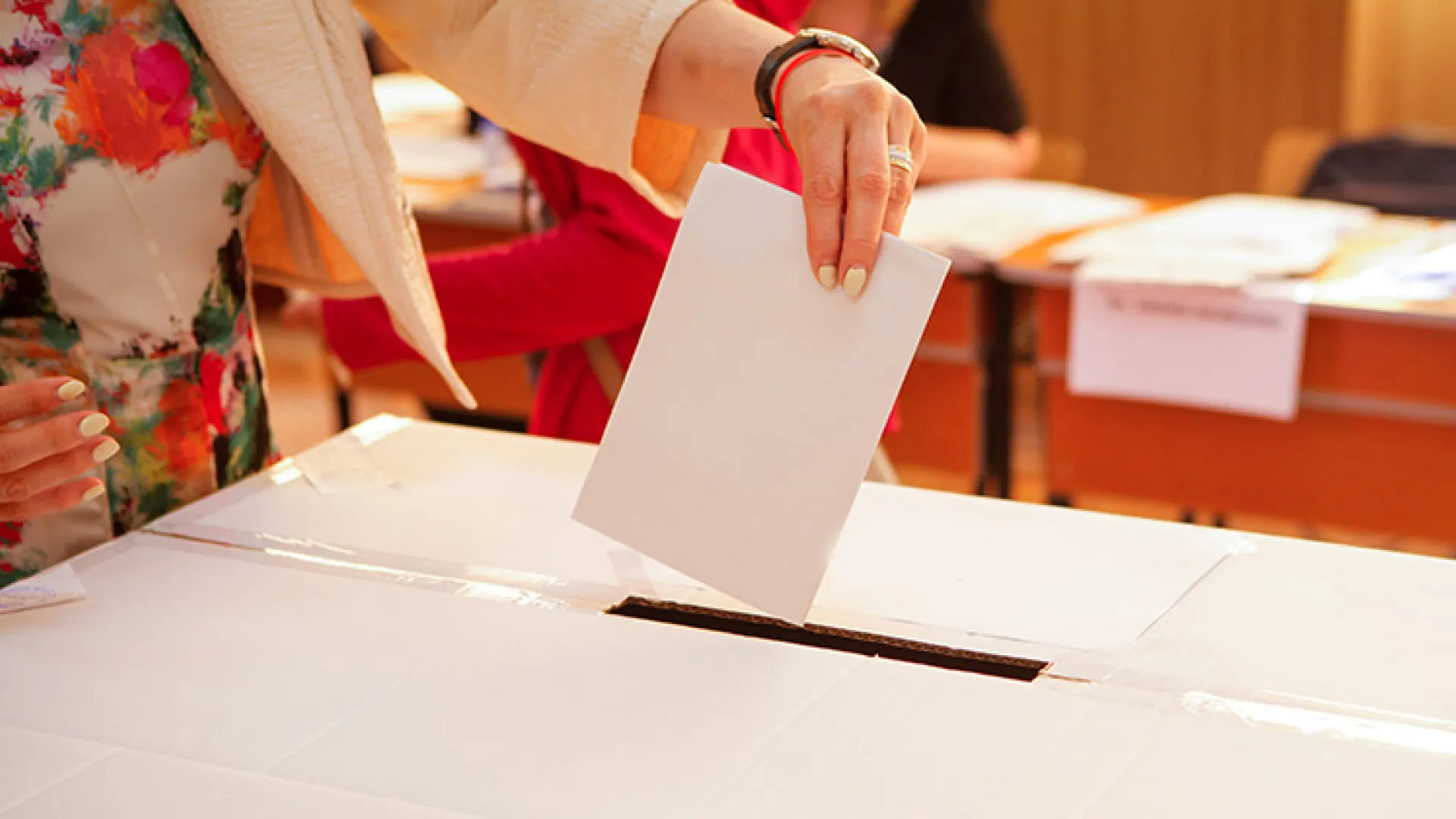 Woman putting ballot into box