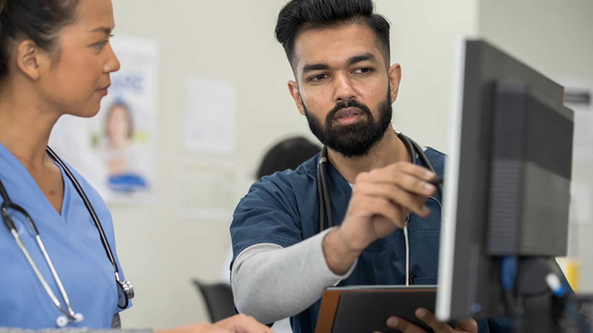 medical workers looking at a computer together