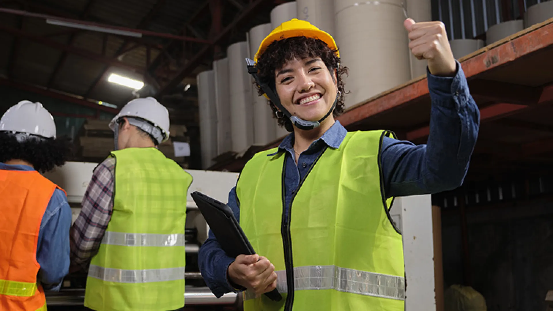 Factory worker giving the thumbs up