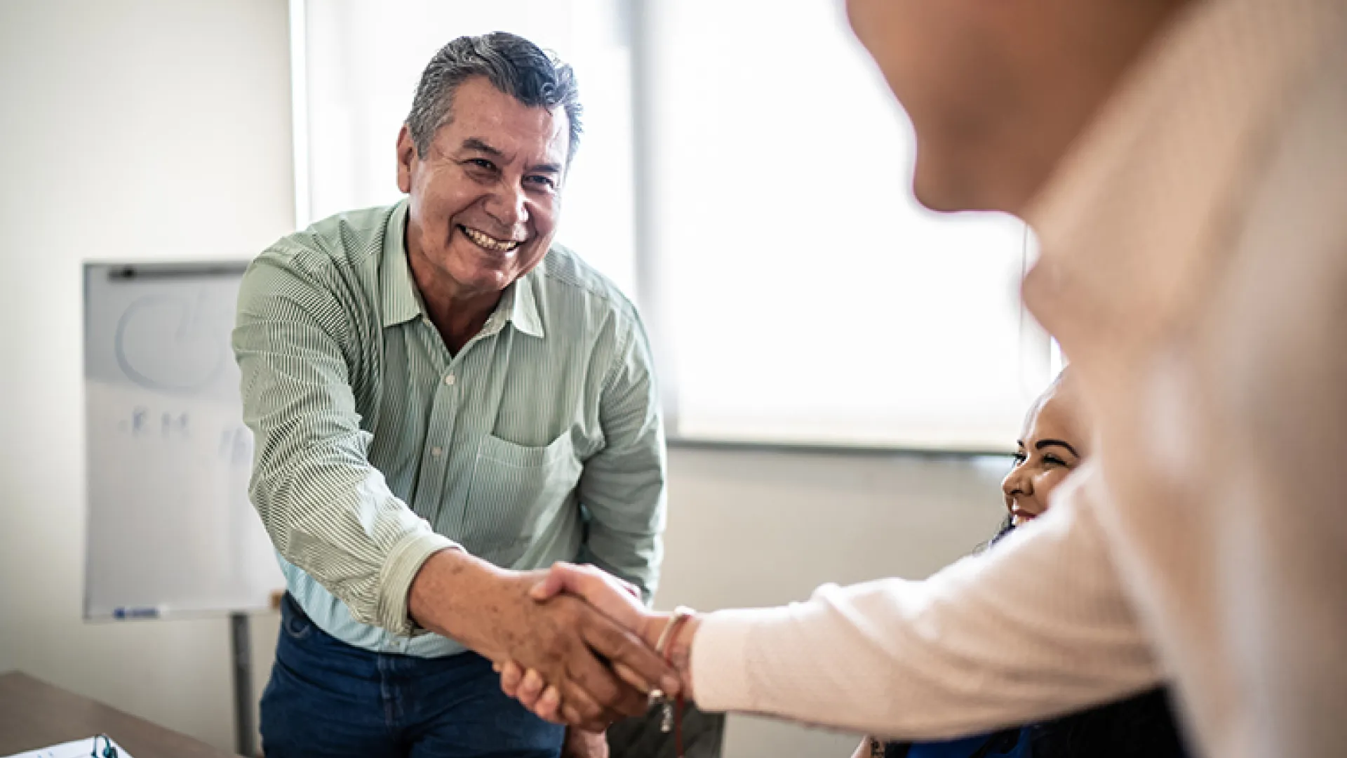 man shaking hands at job interview