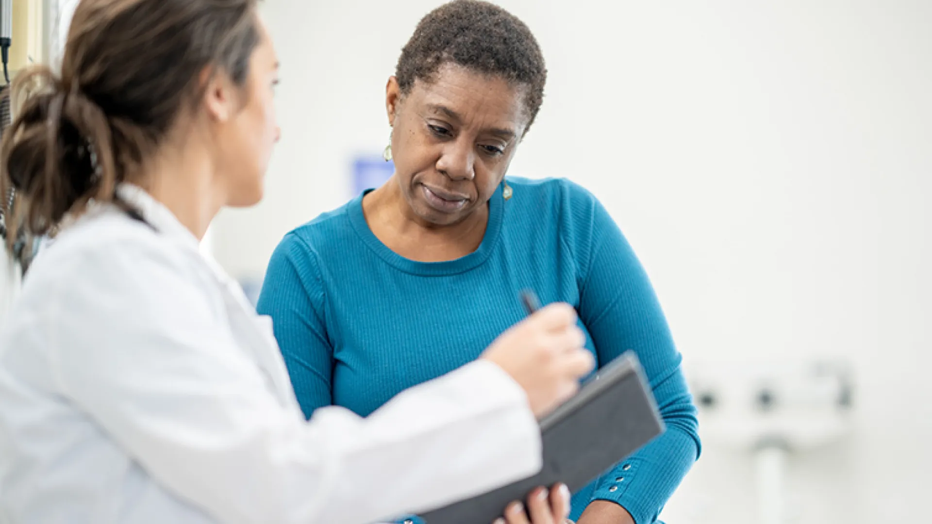 older female patient talking with her doctor