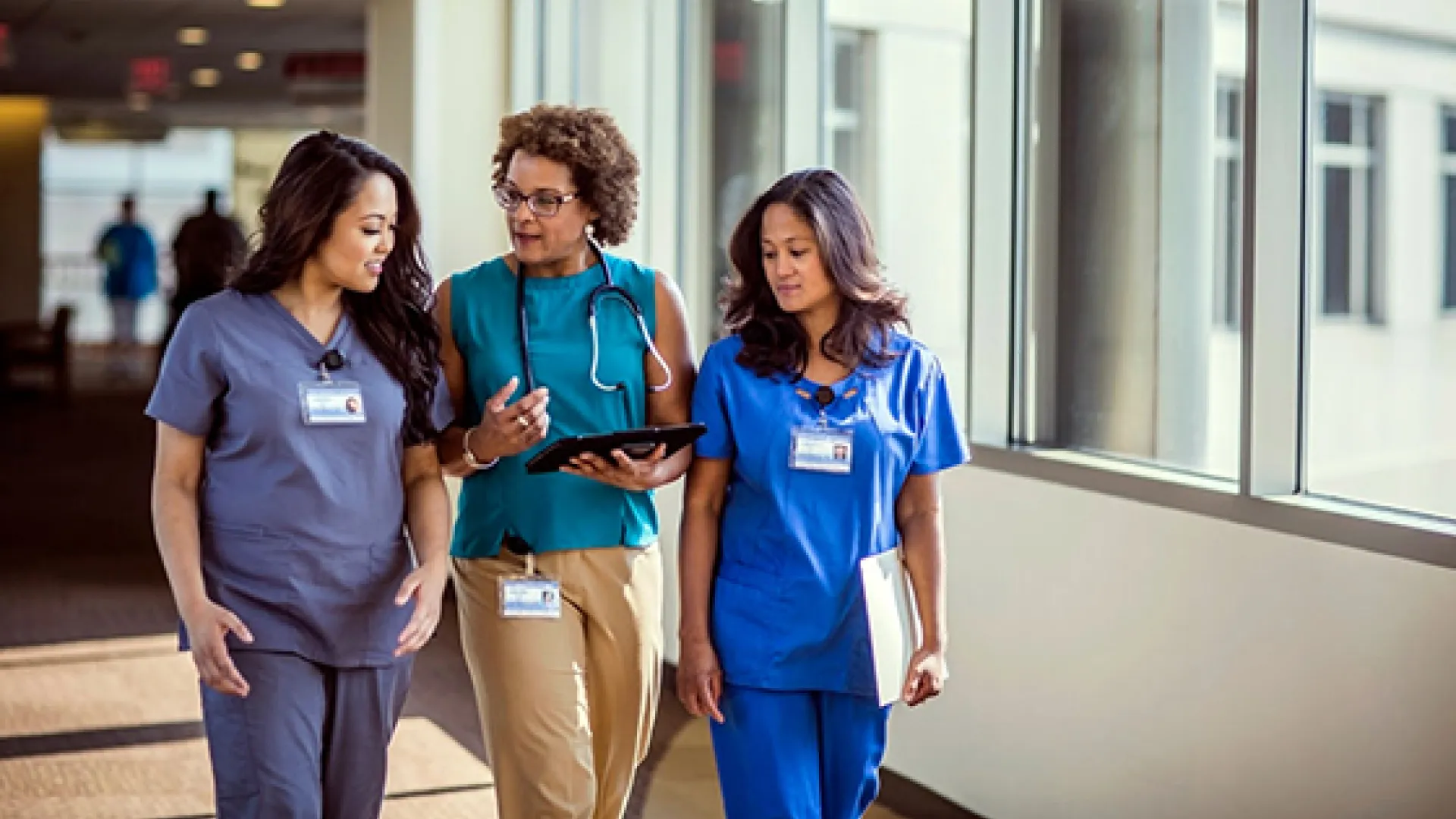Health care workers walking down a hallway