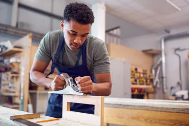 Image of apprentice using a sander