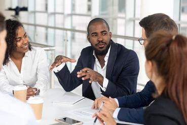 African American man leading a meeting