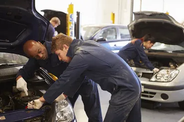 Apprentice working with mechanic
