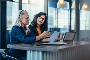 Two women analyzing work together