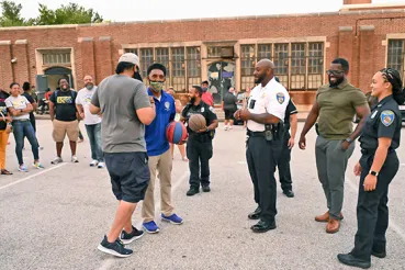 Baltimore police playing basketball with community members